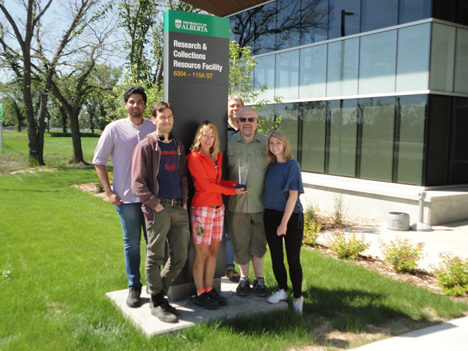 Depository and Fulfillment Team with their award in front of the RCRF Building