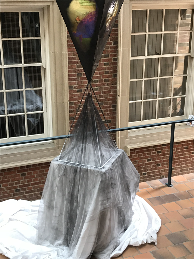 Sculpture in a prism/hourglass