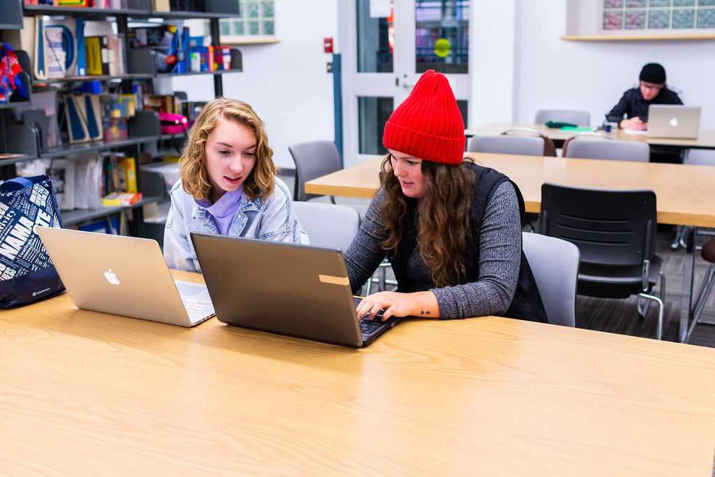 Two students wuth their laptops in BSJ library