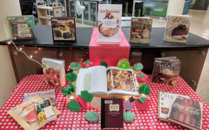 Picnic table set up with cookbooks on it to display Linda's Collection.