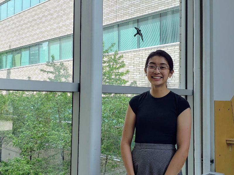 Han smiling in front of a window.