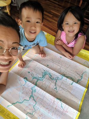 Sonya with her children looking at a map.