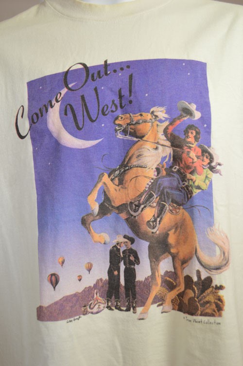 Tshirt featuring slogan "Come Out... West!" and two cowgirls on a horse, while two cowboys embrace in the background.