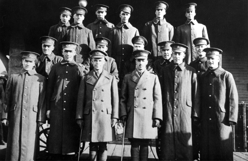 Three rows of soldiers stand facing the camera.