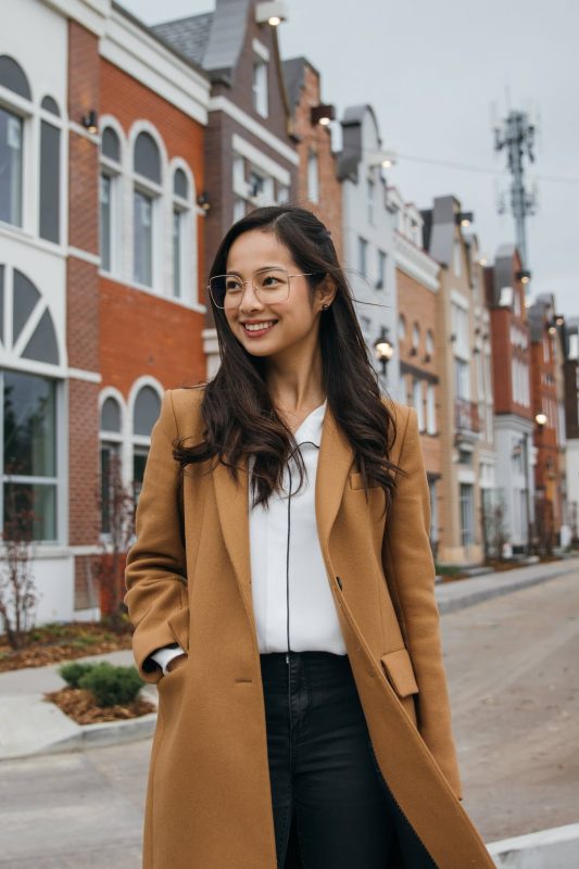 Katrina Aranas in front of Flemish-style building in Edmonton.