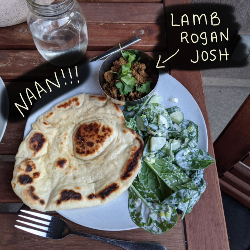 A photo of a plate with naan and lamb rogan josh. Recipes from A Spicy Touch by Noorbanu Nimji