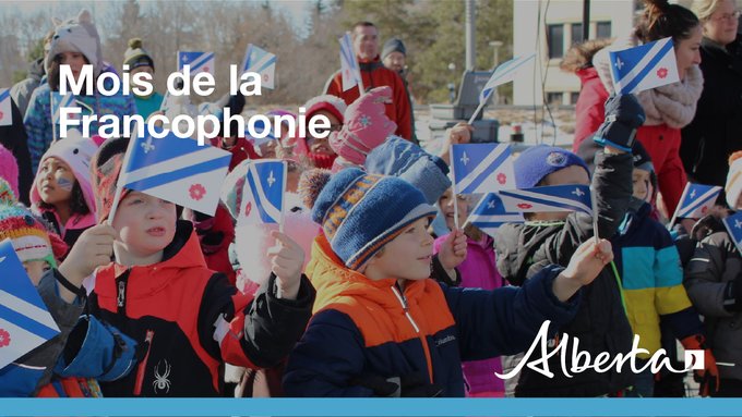 Francophone heritage in Alberta celebration. Children with Alberta francophone flags.